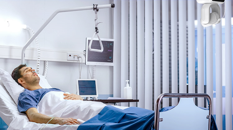 Patient in bed with telehealth camera helping to telesit