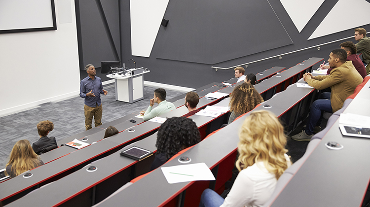 Lecturer speaking in lecture hall to students