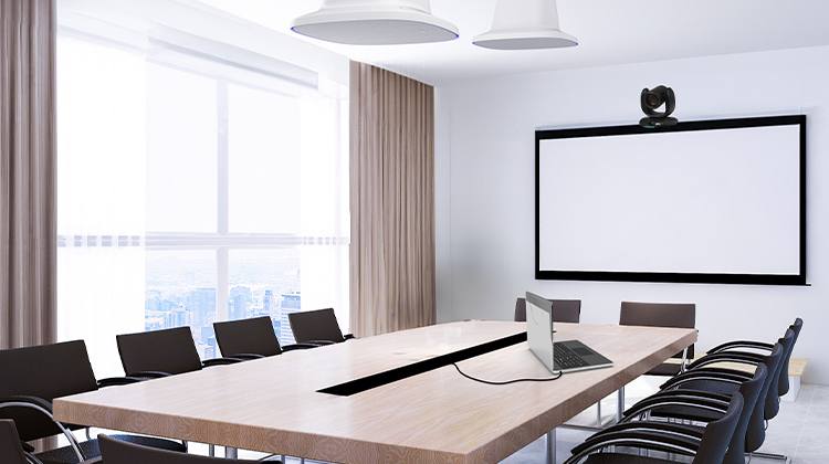 Video conferencing room with camera and ceiling speakerphones